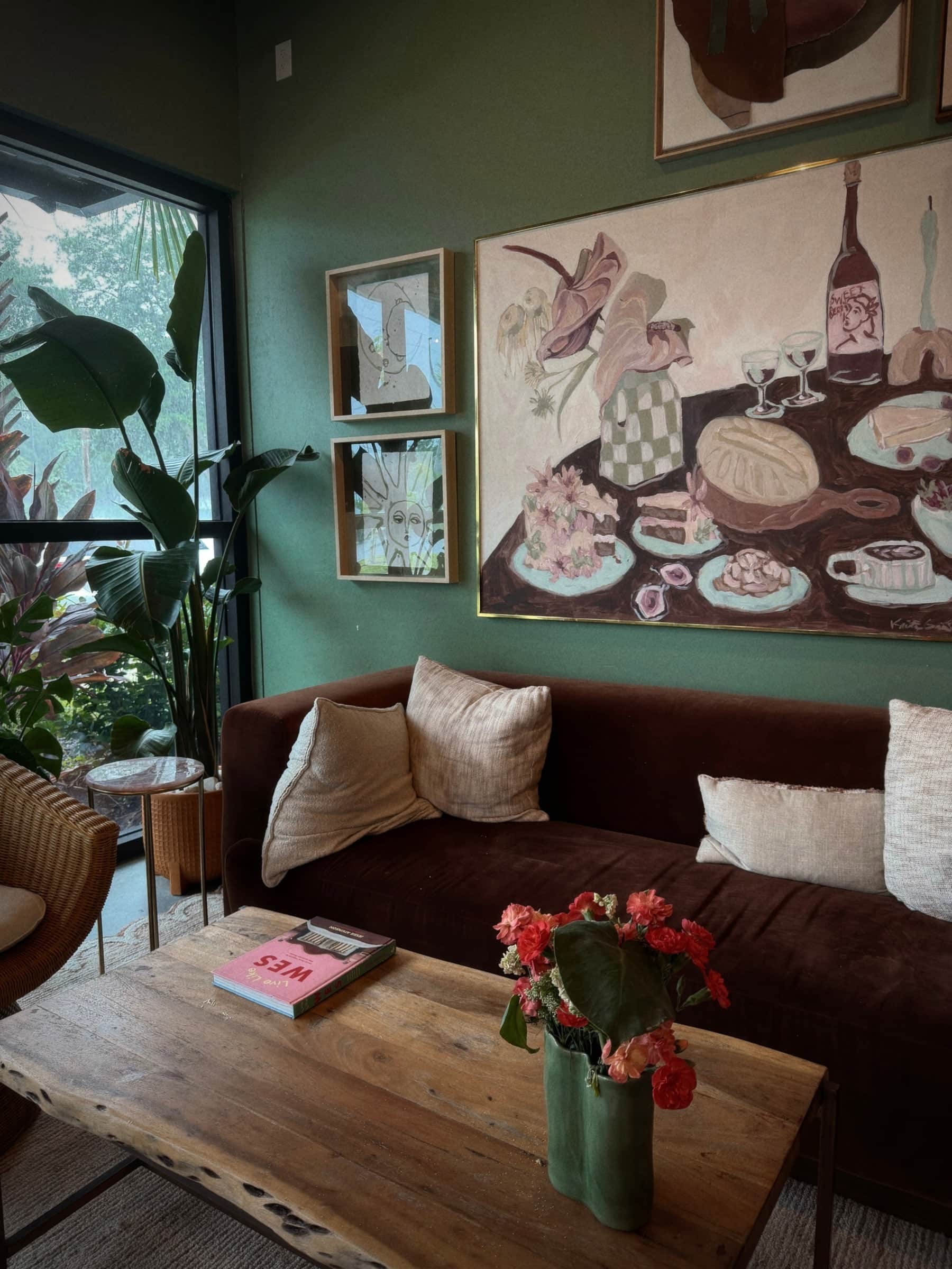 Café lounge with a hand painted tea party mural, leather sofa and fresh tulips