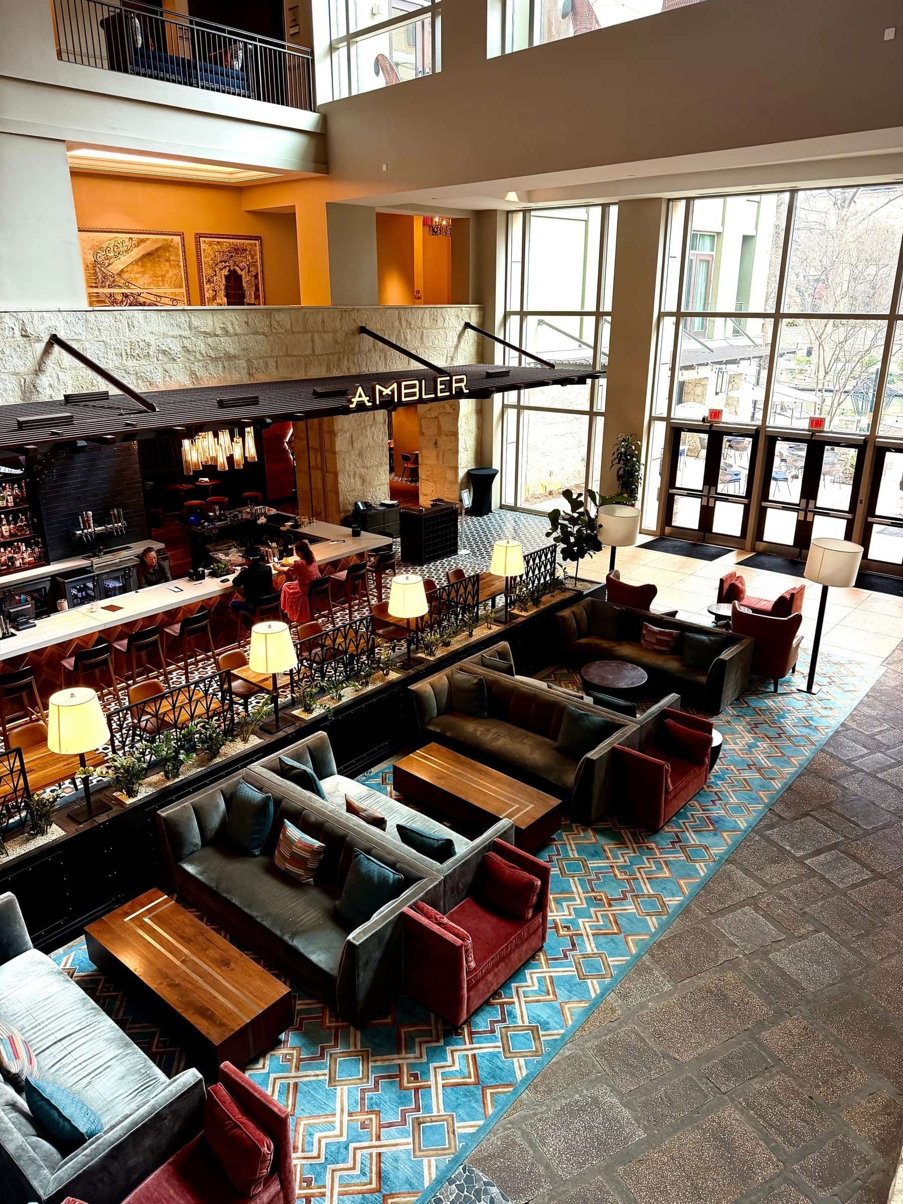 Overhead view of the Ambler bar and lounge with leather seating, patterned tile and warm lamplight